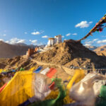Namgyal Tsemo Gompa monastery perched on a red hilltop overlooking Leh town and the snow-capped Himalayan mountains in Ladakh.